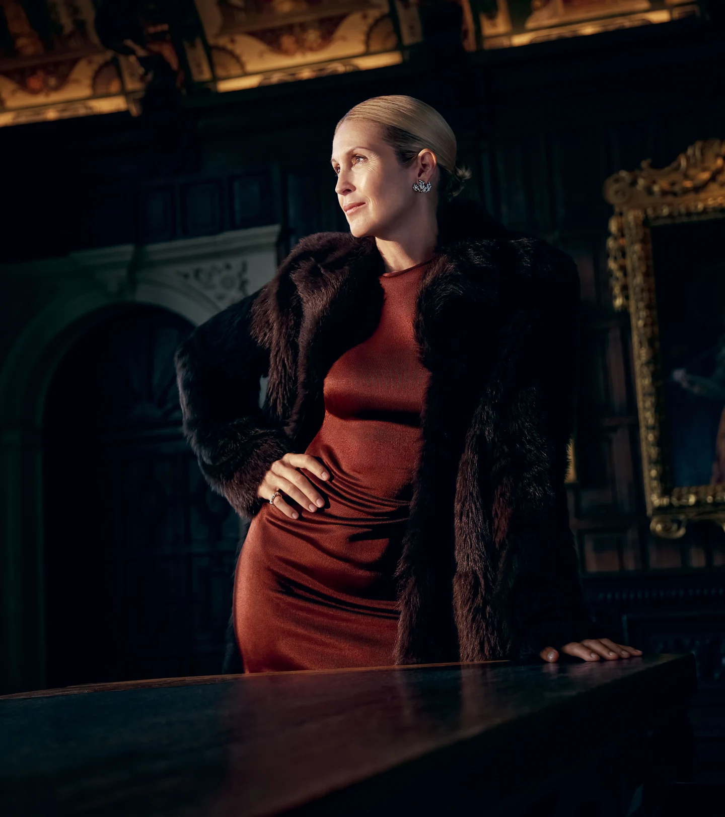Kelly Rutherford wearing a burgundy dress inside an ornate room