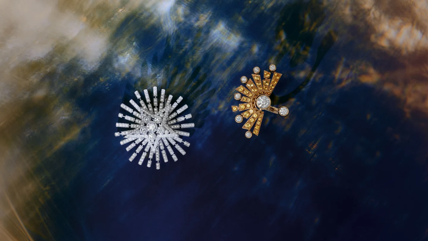 Diamond brooches against a deep blue and gold still life