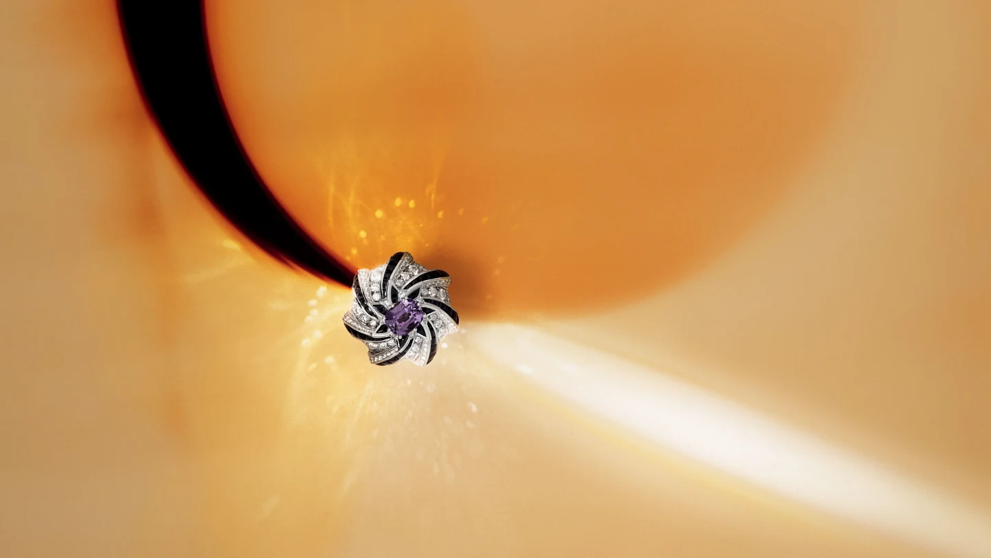 A diamond ring framed by warm orange reflections
