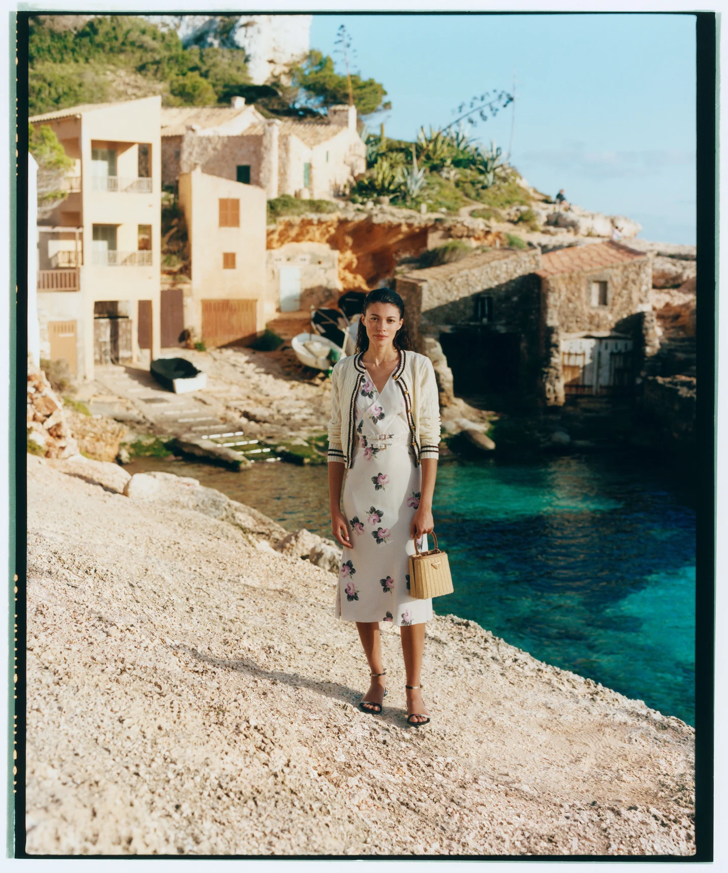 A patterned dress beside a Mediterranean cove